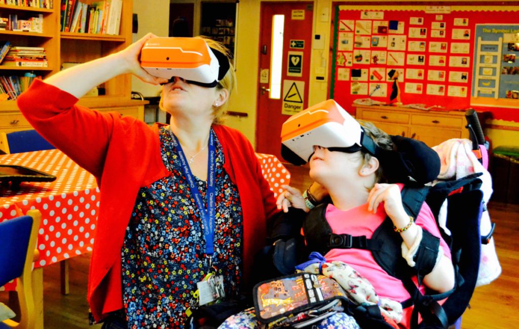 student and support worker with virtual goggles