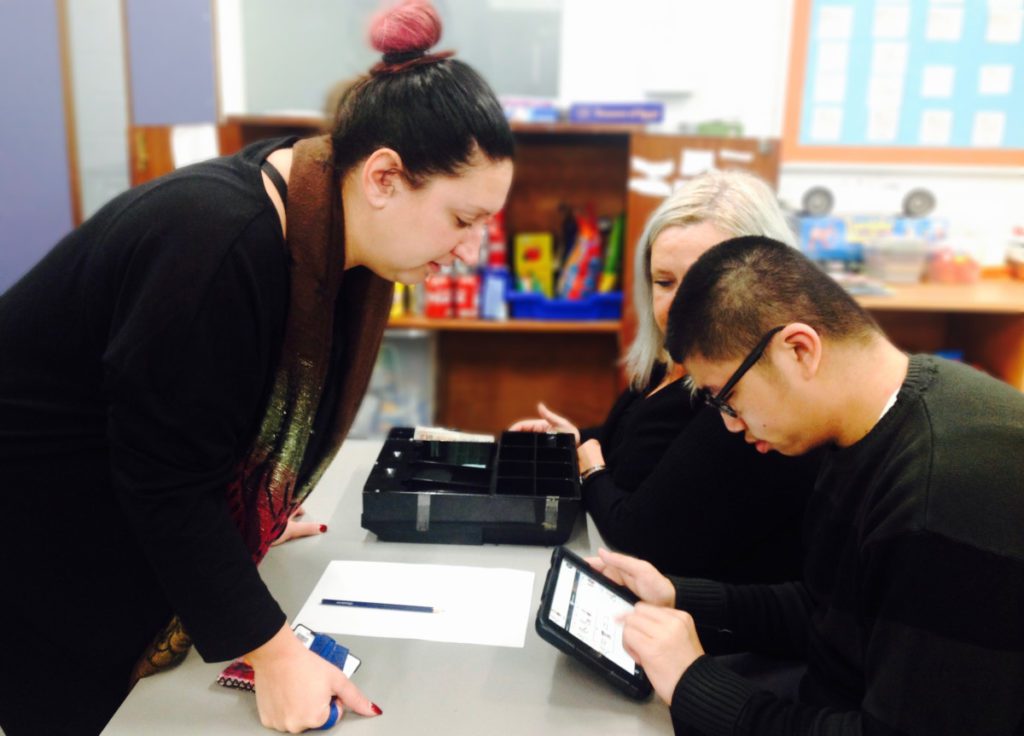 student with supporting staff and ipad