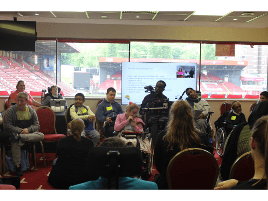 Abdi Omar, AAC Consultant with students from Charlton Park Academy and Highshore School presenting at Communication Works 2023