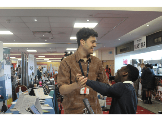 Specialist Teaching Assistant James Dewar-Hassan with students in the exhibition space