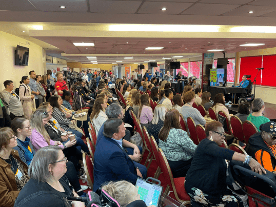 The audience at Communication Works 2023 during Beth Moulam, Paralympian and AAC Advocate's keynote speech