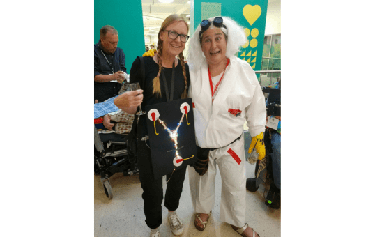 Mary Long and Saffron Murphy-Mann dressed in Back to the Future themed fancy dress at Communication Matters 2023