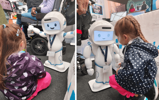 Young visitors at the Tes SEND Show having fun with QT Robot