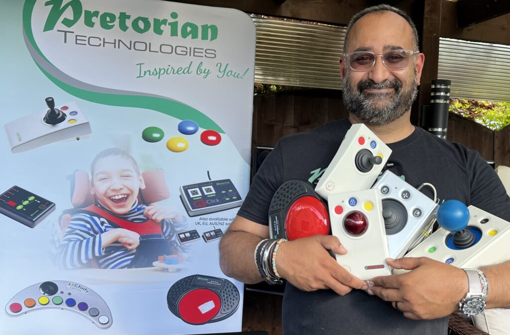 Bob Sagoo from Pretorian Technologies holding a selection of switches and joysticks Bob Sagoo from Pretorian Technologies holding a selection of switches and joysticks