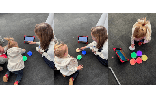 Head of CENMAC Kathryn playing a Cosmo Switches game with little Sofia Head of CENMAC Kathryn playing a Cosmo Switches game with little Sofia