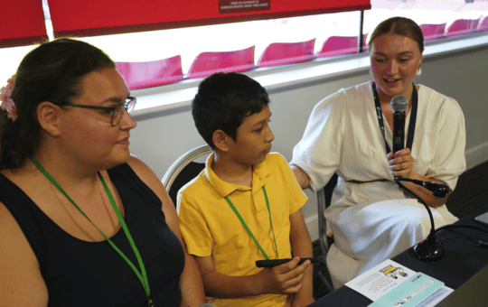 TA Isabelle Taylor presenting at Communication Works 2026 alongside her pupil Denish and his TA at Charlton Manor Primary, Danielle Moriarty